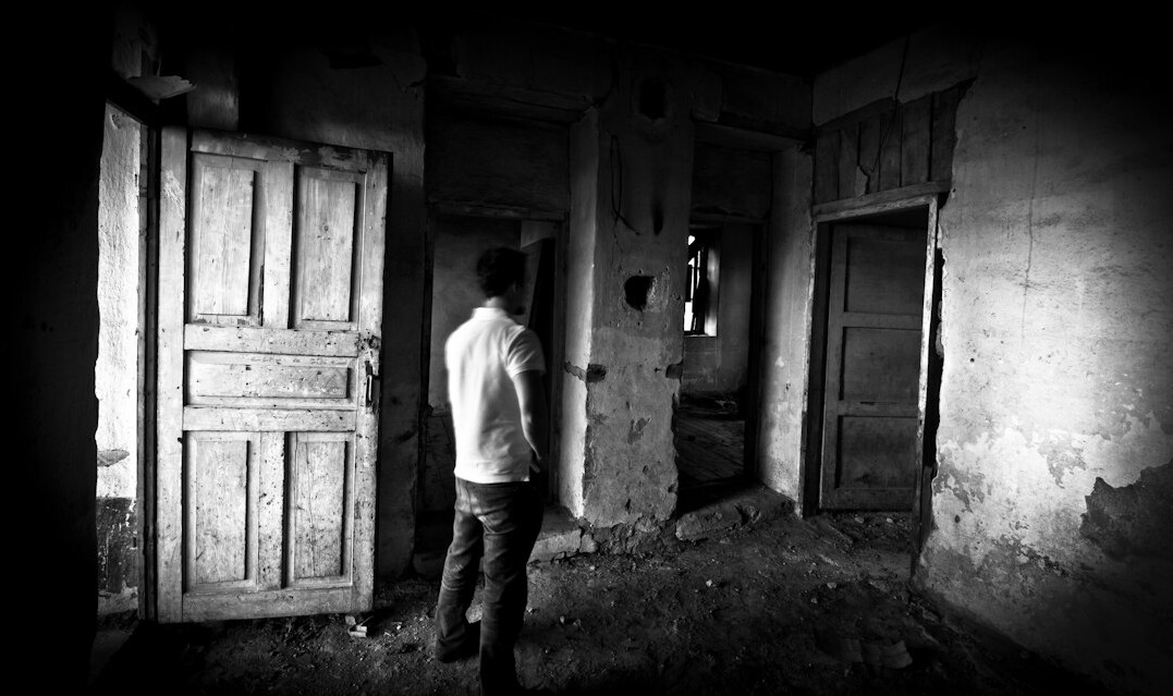 person looking scared in dark room