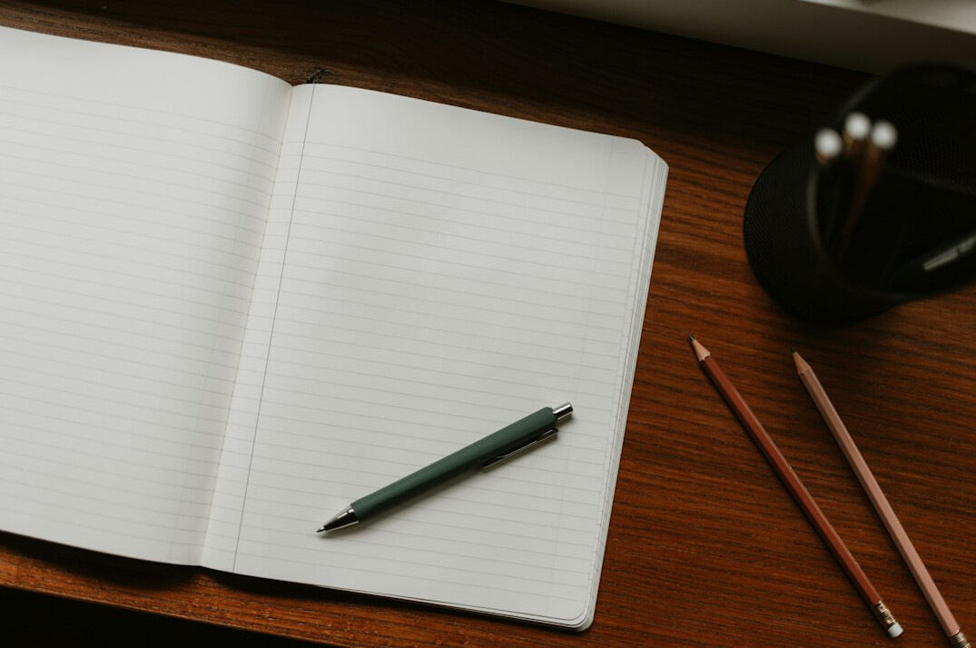 author writing in notebook
